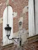 Agen - Facade of a brick house with a lamppost