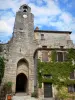 Bruniquel - Porte Méjane gate, clock of the belfry and houses of the medieval village 