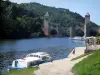 Cahors - Bank, the River Lot, boats, Valentré bridge (fortified bridge) and hill, in the Quercy