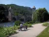 Cahors - Walk lined with flowers and view of the Valentré bridge (fortified bridge), the River Lot and trees, in the Quercy