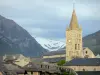 Embrun - Bell tower of the Notre-Dame-du-Réal cathedral and houses of the old town with view of the mountains; in the Durance valley