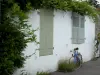 Île de Noirmoutier - Noirmoutier-en-l'Île : maison blanche ornée de glycine (plante grimpante) et vélo (bicyclette) posé contre la façade