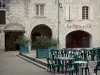 Lauzerte - Medieval Bastide fortified town: arcaded stone houses and café terrace of the Place des Cornières square 