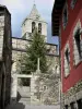 Llivia - Bell tower of the Notre-Dame-des-Anges church and colorful facade of a house