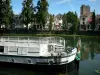 Melun - Banks of River Seine: moored barge, river, facades of the town and trees along water