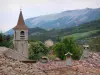 Orpierre - Church bell tower and roofs of the houses in the village with view of the mountain