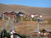 L'Alpe d'Huez - Winter and summer sports resort (ski resort): chalets, ski lifts and grassland in autumn