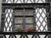 Angers - Timber-framed house and its carved characters, its window decorated with flowers