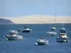 Arcachon bay - Boats floating on the waters of Arcachon with a view of the Pilat dune 