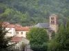 Ardes - Bell Tower of the Saint-Dizaint church and town houses surrounded by trees; in the Auvergne Volcanic Regional Nature Park