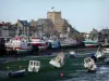Barfleur - Port: small leisure boats at ebb tide, fishing boats moored to the quay, granite houses and church of the village, in the Cotentin peninsula