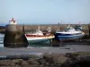 Barfleur - Cliffs, gulls, fishing boats at ebb tide, pier and light of the port