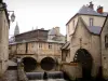 Bayeux - The ancient tanners and dry cleaners district: Aure river, watermill, houses, lamppost, former fish covered market hall, and the towers of the Notre-Dame cathedral