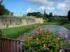 Bergues - Los geranios (flores) en el primer plano, las paredes del canal (fortificaciones, las mujeres embarazadas) de la ciudad amurallada, señaló la torre y la torre cuadrada de la abadía de Saint-Winoc y los árboles