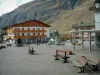 Bessans - Main square of the village with benches, chalets and mountain, in Haute-Maurienne (peripheral zone of the Vanoise national park)