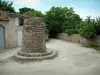 Bonnieux - Square with stone construction, house and trees