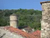 Boussagues - Tower of the Bailli house, roofs of the medieval village and trees