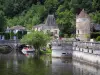 Brantôme - Dronne river, bridge Coudé in background, pavilion of the Renaissance period, Saint-Roch tower, houses and trees, in Green Périgord