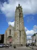 Bressuire - Bell tower and facade of the Notre-Dame church, houses of the town, clouds in the blue sky