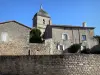 Brigueuil - Espadaña de la iglesia de San Marcial, muros de piedra y casas en la aldea