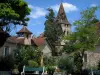 Carennac - Houses of the village, trees and bell tower of the Saint Pierre church, in the Quercy