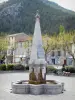 Castellane - Fountain of the Marcel Sauvaire square, trees and houses of the old town