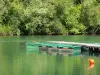 Cergy-Pontoise leisure island - Pond, boats moored to a pontoon, and trees along the water