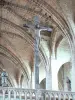 La Chaise-Dieu Abbey - Inside the Saint-Robert abbey church: crucifix and statues of the Virgin and the apostle Saint John overlooking the rood screen