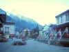 Chamonix-Mont-Blanc - Winter and summer sports resort (climbing capital): square with benches, flags, houses and view of the Mont Blanc mountain range