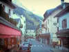 Chamonix-Mont-Blanc - Winter and summer sports resort (climbing capital): shopping street lined with houses and shops, Mont Blanc mountain range in background