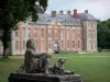 Château de Chamarande - Departmental Domain of Chamarande: sculpture (statue) of a stepped cascade in the foreground, lawns of the park and facade of the Louis XIII-style château
