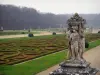 Château de Vaux-le-Vicomte - Statue in the foreground with a view of the embroidery-like flowerbeds of the formal gardens of Le Nôtre