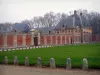 Château de Vaux-le-Vicomte - Outbuildings made of brick and stone, lawn