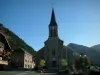 Châtel - Church, houses of the village (winter and summer sports resort) and mountains covered with forests, in Chablais