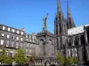 Clermont-Ferrand - Notre-Dame-de-l'Assomption cathedral of Gothic style made of lava stone, with its two steeples, Victoire square with the statue of Urbain II and facades of buildings of the old town