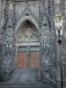 Clermont-Ferrand - Portal of the Notre-Dame-de-l'Assomption cathedral of Gothic style made of lava stone; lamppost