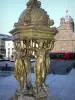 Clermont-Ferrand - Caryatids of the Wallace fountain, Jaude square, dome of the Saint-Pierre-les-Minimes church and tram in the background