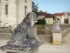 Commarin castle - Statues of lions guarding the entrance to the bridge