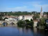 Confolens - Vieux bridge spanning the River Vienne, bell tower of the Saint-Maxime church, trees and houses of the medieval town