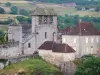 Curemonte - Campanario con tres bahías de la iglesia y las casas de piedra de Saint-Barthélemy de la villa medieval