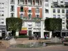 Douai - Buildings, cut trees, shops and fountains of the Armes square