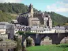 Estaing - Old gothic bridge spanning River Lot, houses of the medieval town and Estaing castle dominating the place