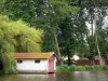 Estanque de Soustons - Barco de camara a la orilla del agua y el banco de arbolado