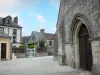 Exmes - Portal of the Saint-André church and houses of the village