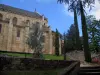 Figeac - Notre-Dame-du-Puy church, stair, lawns, cypress and trees, in the Quercy