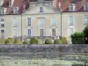 Fontaine-Française castle - Facade of the castle, topiaries of the French garden and pond dotted with water lilies