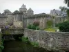 Fougères - Nançon river, flowers, shrubs, ramparts and towers of the medieval castle