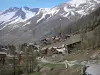 La Foux d'Allos - Road, chalets of the ski resort of Val d'Allos 1800, trees and mountains with snowy tops