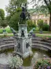 Gardens of the Palace of Fontainebleau - Diane fountain and its dogs made of bronze, flowers and trees of the Diane garden