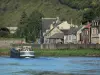 Givet - Meuse valley, in the Ardennes Regional Nature Park: barge sailing on River Meuse and houses of the town